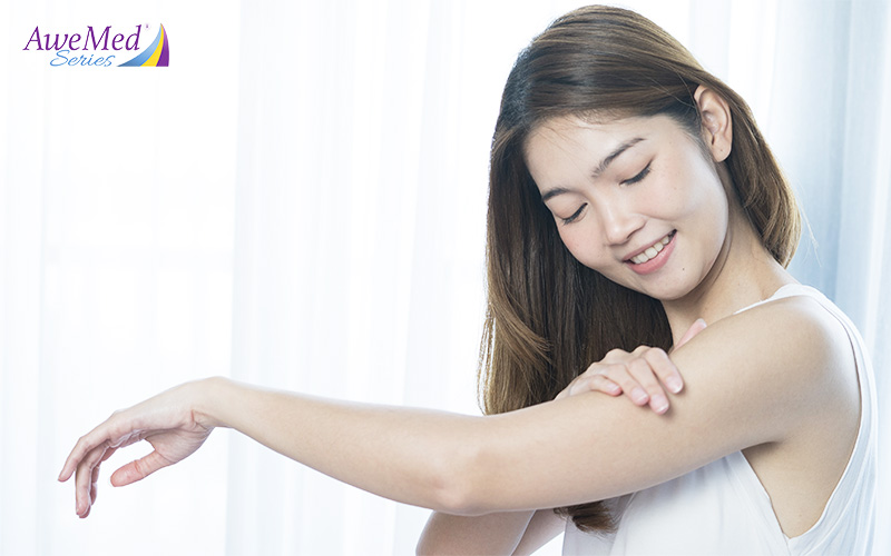 Person Applying Moisturizer to the Arm